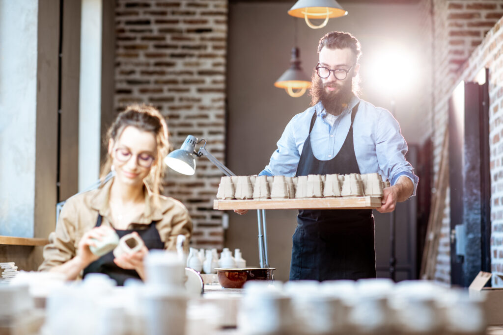 Man and woman working in the pottery shop