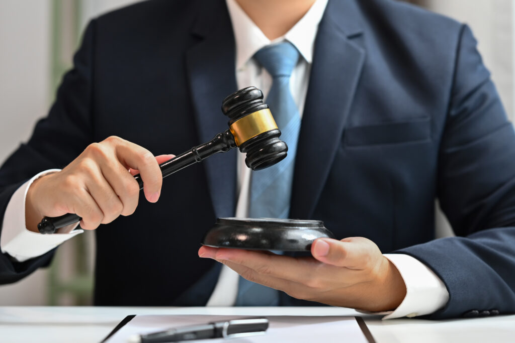 Unrecognizable judge holding wooden gavel. Lawyer, justice and law, attorney concept